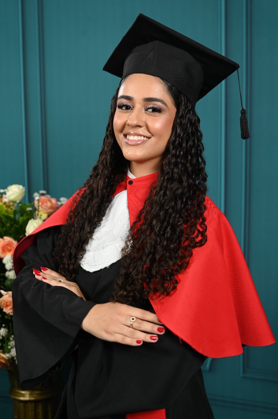 Formanda de beca vermelha e capelo